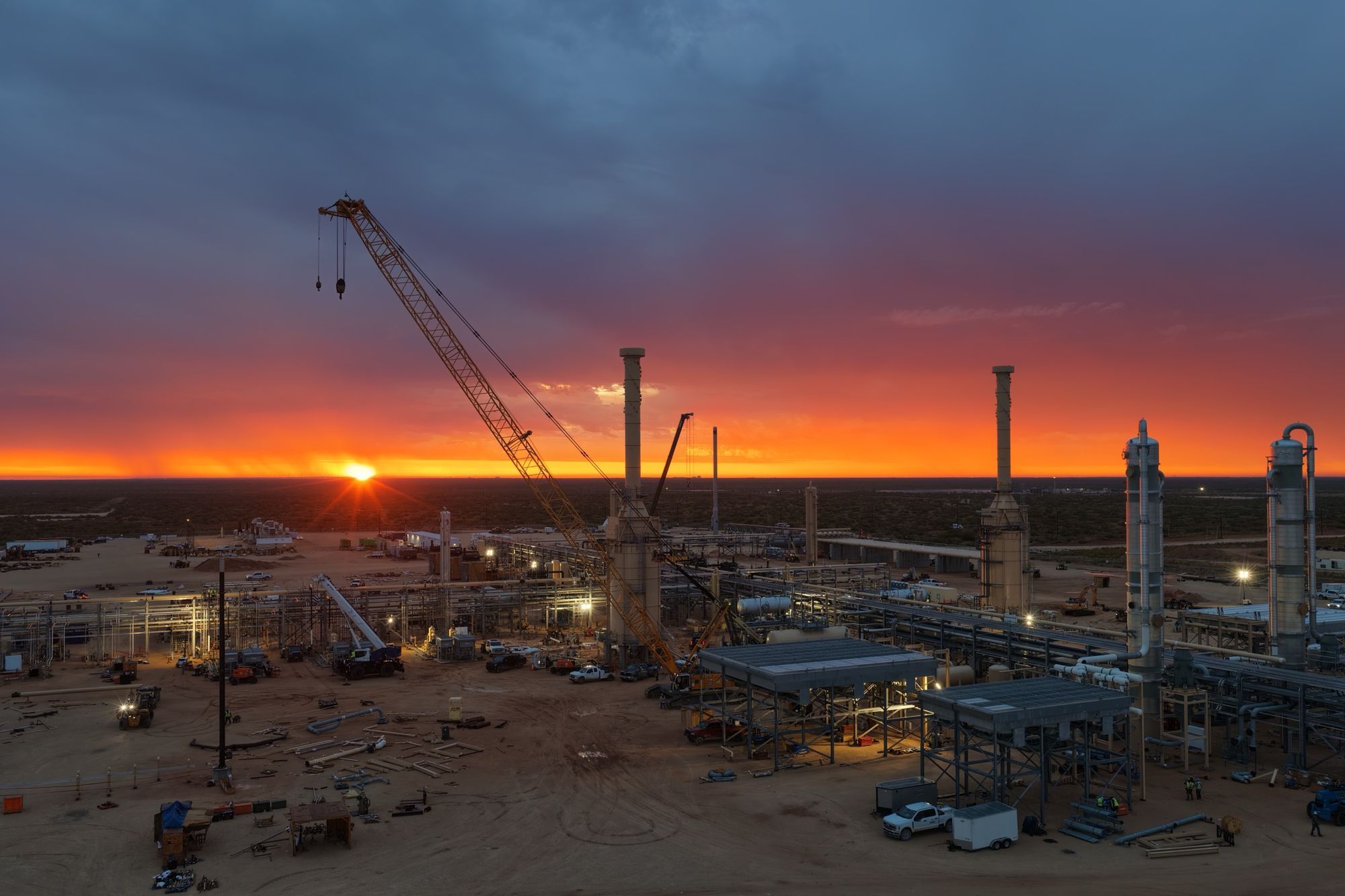 Gas processing plant under construction at sunset
